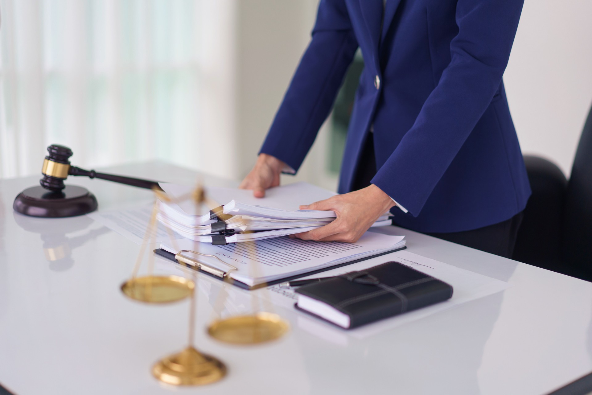 Lawyer woman hold document and working about business contract with legal agreement in legal office
